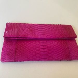 Snakeskin Fuchsia clutch bag.